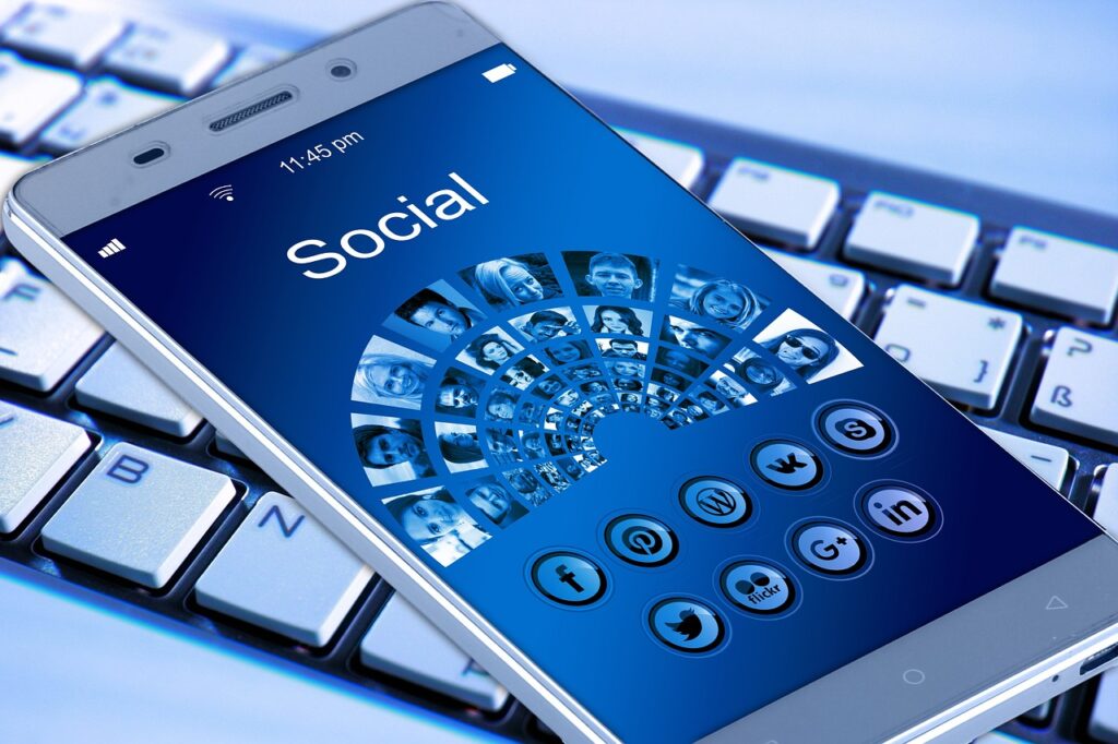 Smartphone displaying popular social media apps like Facebook, Instagram, and Twitter, symbolizing social media management and engagement.