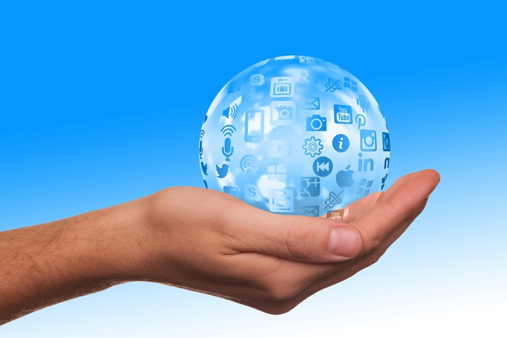 Hand holding a globe with marketing icons, symbolizing global marketing strategies and digital outreach.